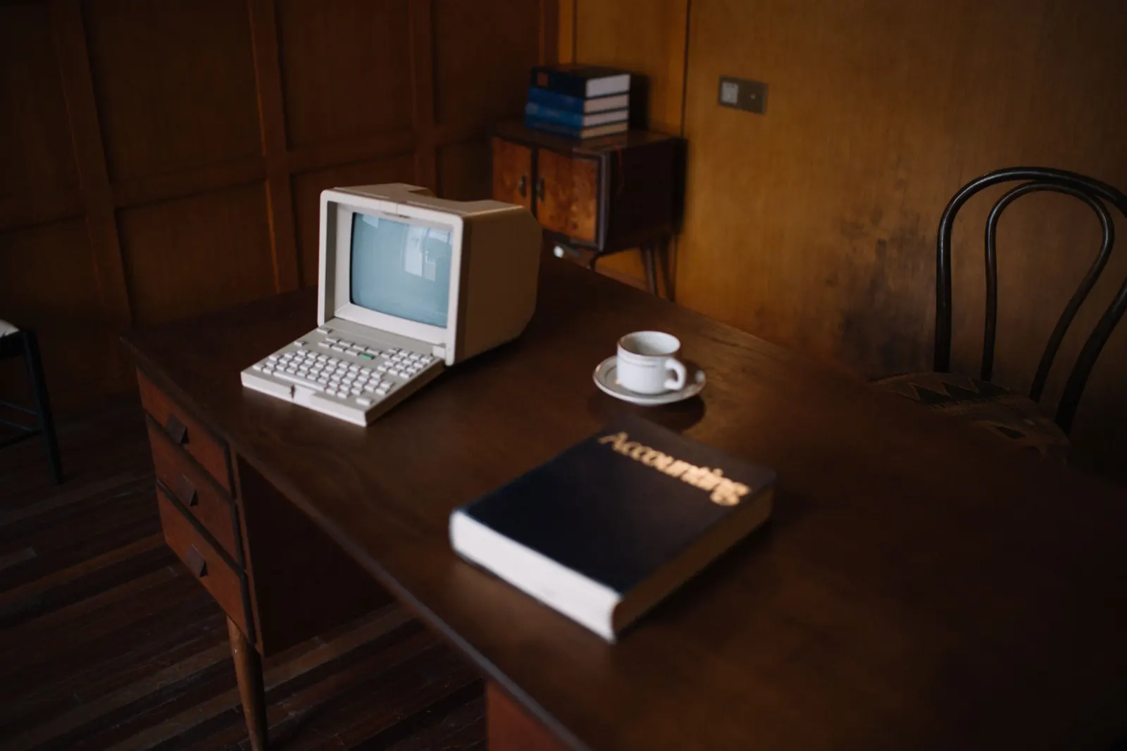 Vintage computer on a warmly lit wooden desk
